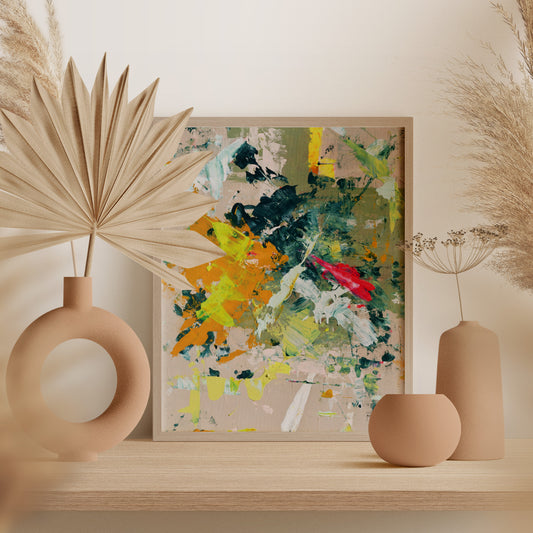 Abstract framed wall art with expressive brushstrokes in green, yellow, orange, red, and white, displayed on a wooden shelf with beige ceramic vases and dried pampas grass.